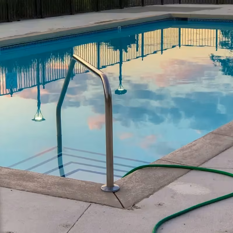 Large outdoor resort pool reflecting a clear sky